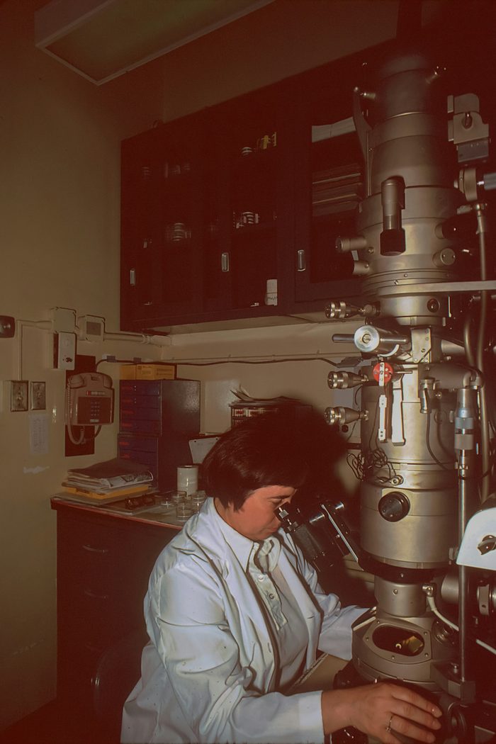 Researcher using specialist microscope equipment in a laboratory