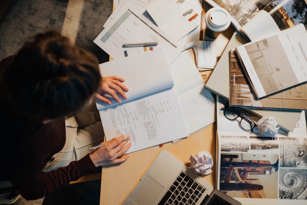 Editor reviewing a manuscript at a desk